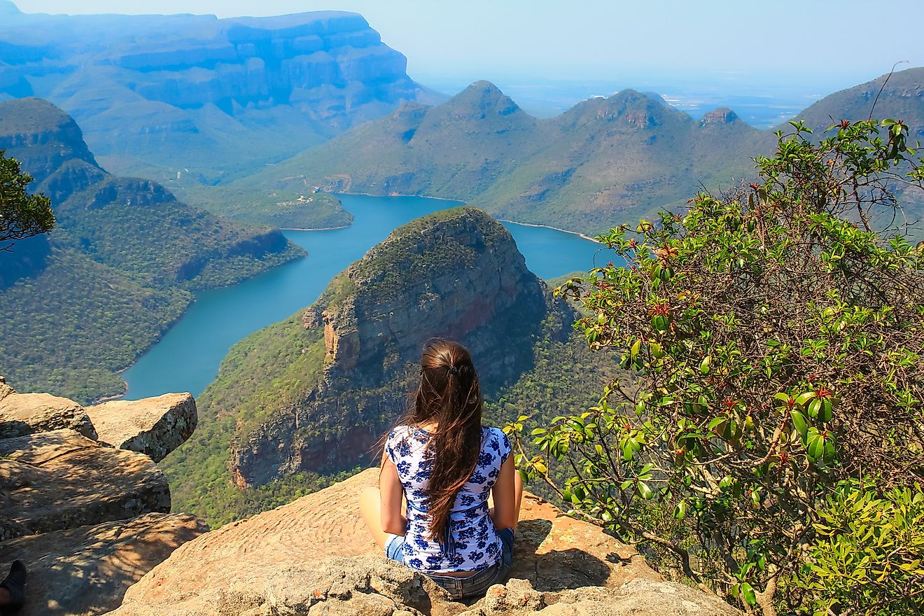 Girl sitting on stone on the cliff in the Blyde River Canyon, South Africa. Image credit: GuilhermeMesquita/Shutterstock.com