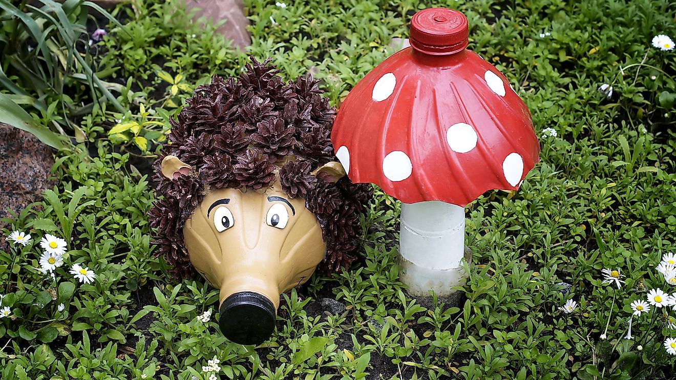 Recycling: a hedgehog and a mushroom made of plastic bottles in a garden. Image credit: Coltty/Shutterstock.com