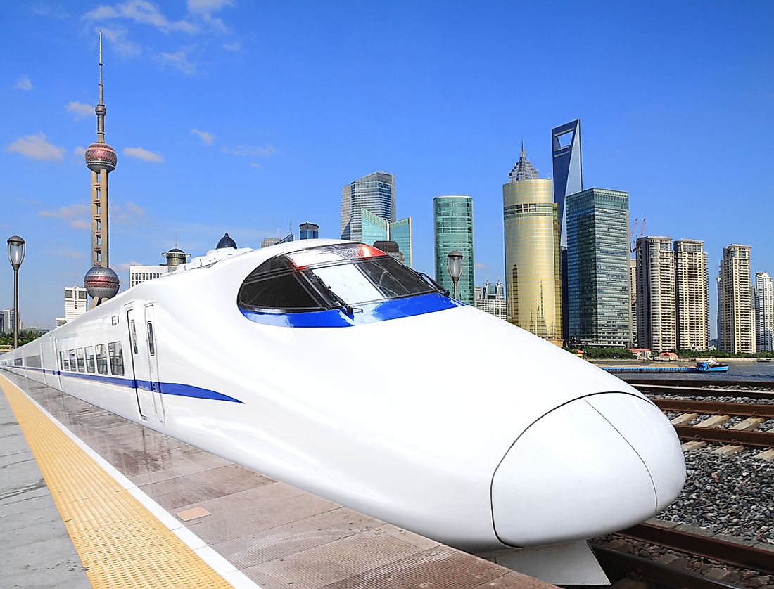 A high speed train with Shanghai in the background. 