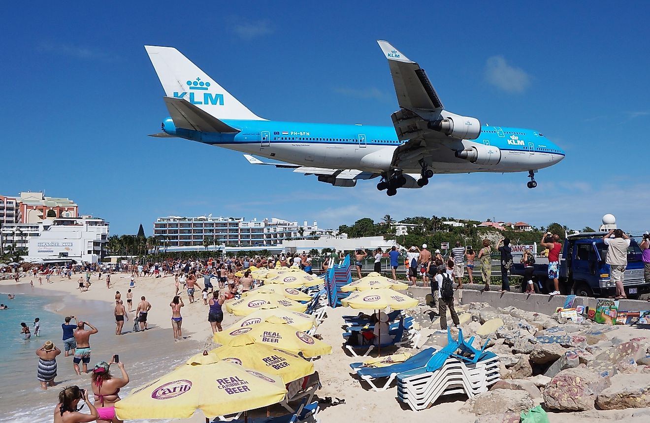 The beach at Maho Bay is one of the world's premier planespotting destinations. Airplanes landing at the Princess Juliana Airport fly over beachgoers. Image credit:  EQRoy/Shutterstock.com