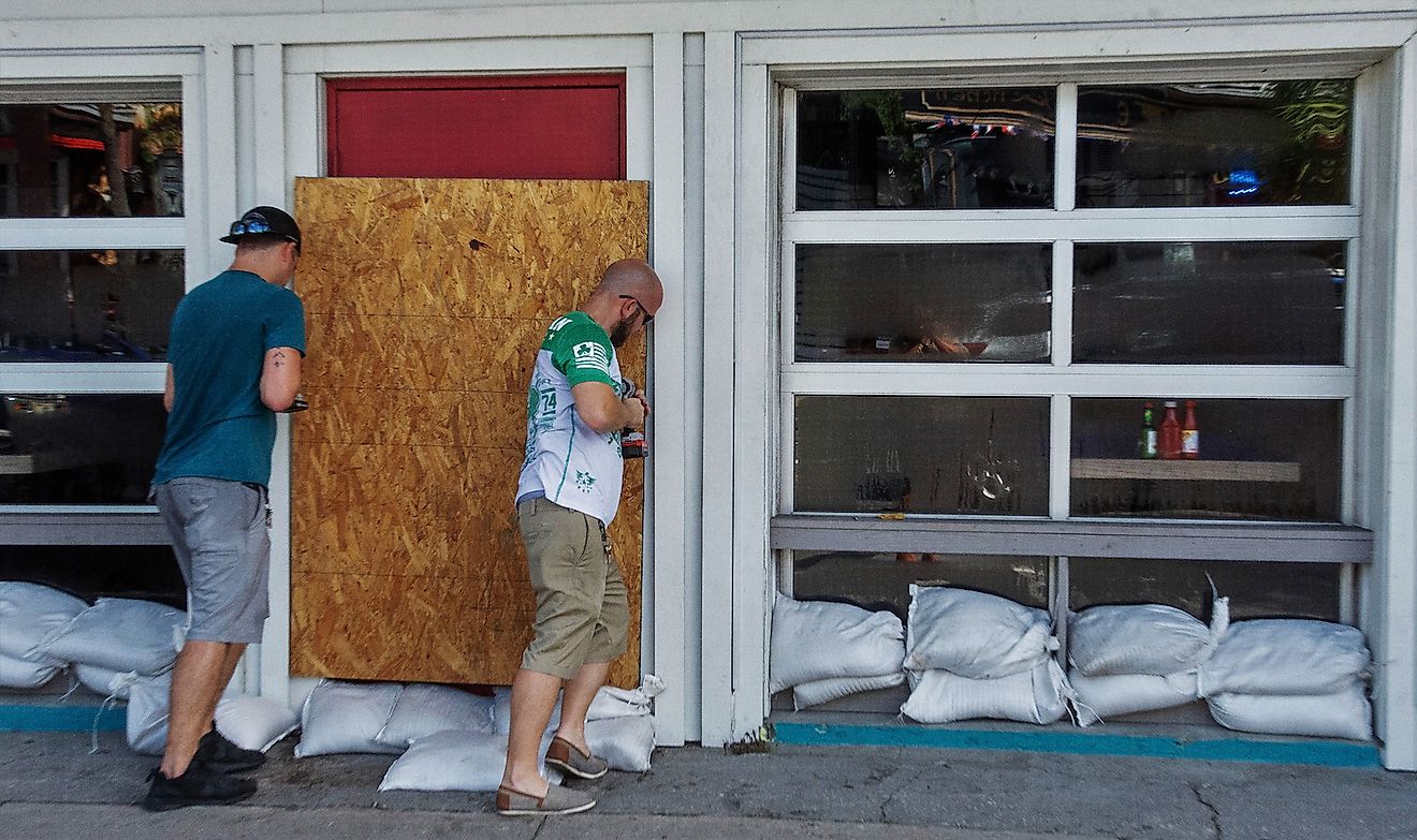 Workers board windows at a restaurant in preparation for Hurricane Florence. Image credit: Prentiss Findlay/Shutterstock.com