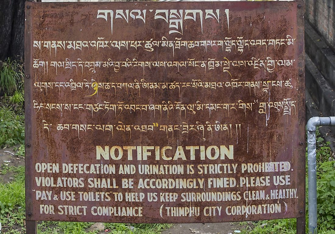 A sign in English and Dzongkha. Editorial credit: PiercarloAbate / Shutterstock.com.
