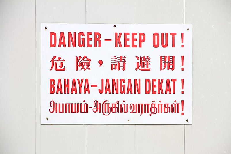 This sign in Singapore warns people in Mandarin Chinese, English, Malay, and Tamil.