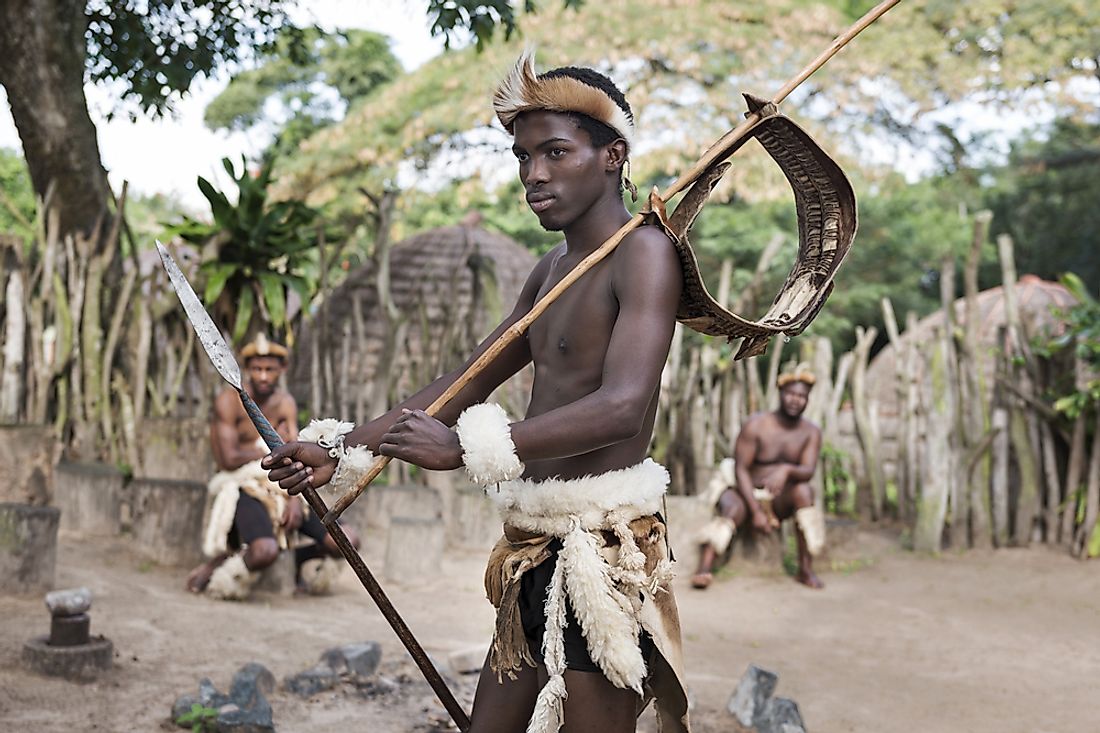 A Zulu warrior in traditional dress in Khula, a Zulu village in South Africa. Editorial credit: Jazzmany / Shutterstock.com