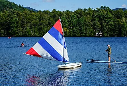 Water boarder enjoys summer day on Mirror Lake in Lake Placid, New York. Image credit Leonard Zhukovsky via Shutterstock