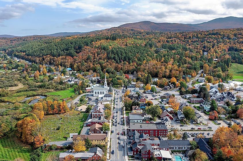Aerial view of Stowe, Vermont, and the Green Mountains with autumn colors.