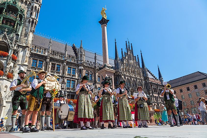 Music band in traditional bavarian clothes in front of Marienplatz town hall in Munich, Germany