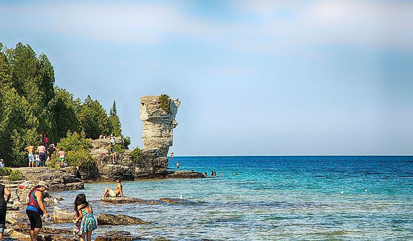 People sunbathing and swimming at Flower Pot Island, Tobermory, Ontario, Canada.