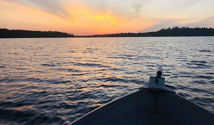 Looking out from the bow of a boat, summer sunset on Northwood Lake