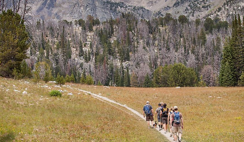 Hikers walking along trail to the Beehive Basin near Big Sky, Montana.