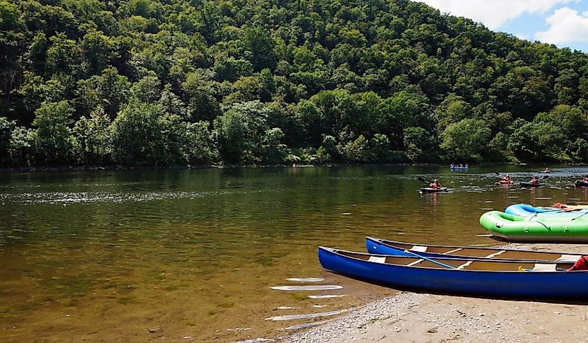 Kayakers in the Delaware River and Canoes and Rafts on the Shore at the Delaware Water Gap in Pennsylvania
