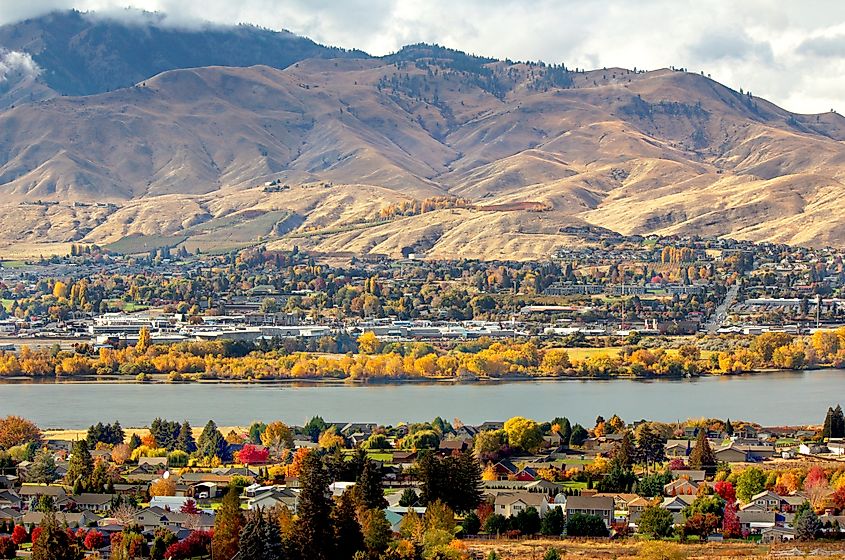 An air view of Wenatchee, Washington, shows the town with majestic mountains in the background.