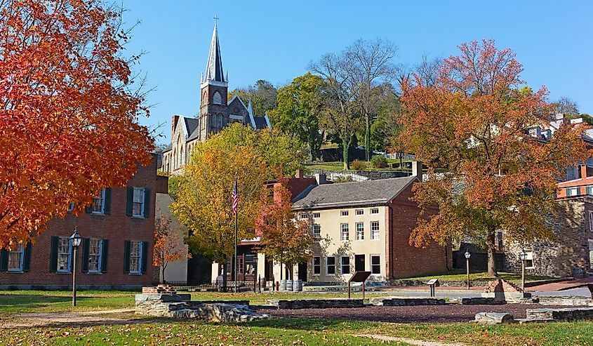 Harpers Ferry historic town in autumn, West Virginia, USA. St. Peter's Catholic Church and historic town buildings.