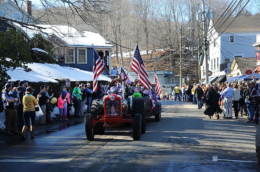 A tractor parade makes its way through Chester, Connecticut during a winter festival.