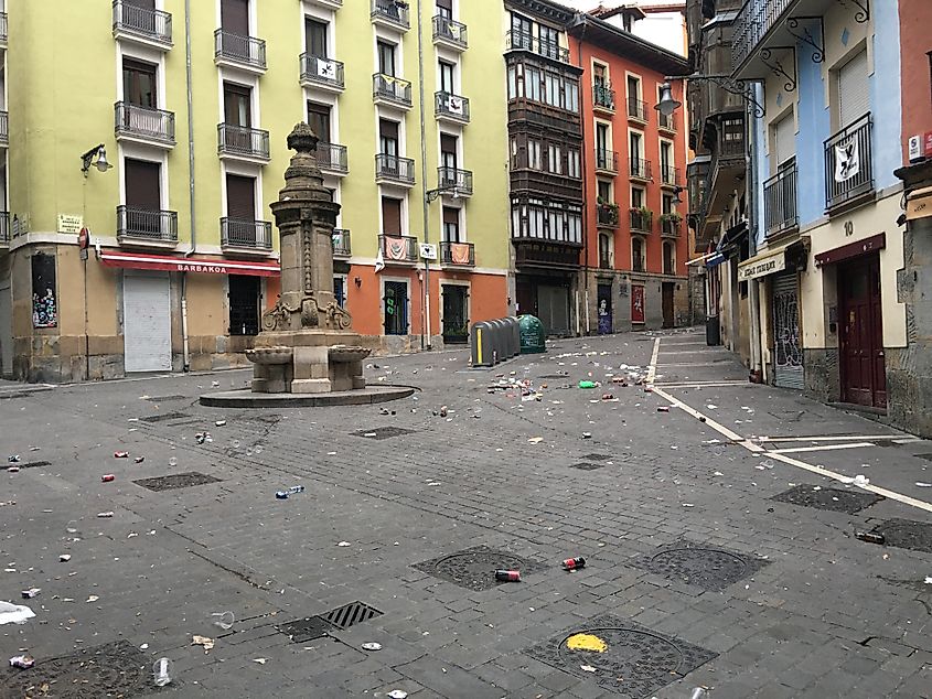 The colorful old town streets of Pamplona, Spain, littered with garbage. 