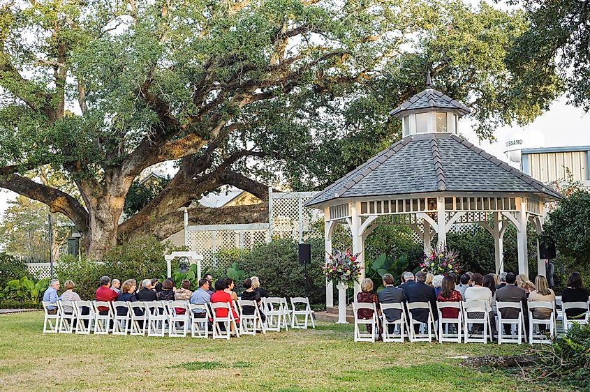 People sitting in front of a gazebo at the Victorian Plantation in Broussard.