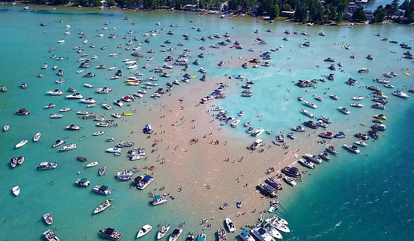 Aerial view of Torch Lake's sandbar with many boats