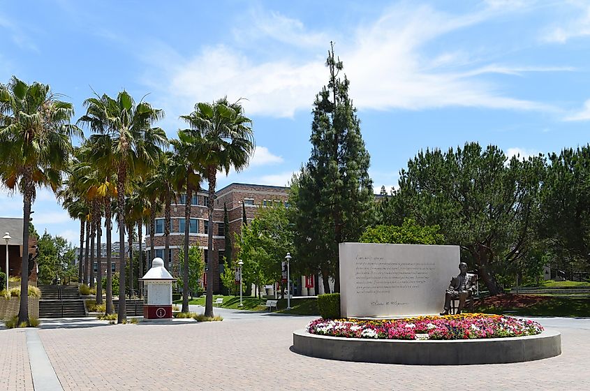 Charles Chapman Statue with Leatherby Libraries in the background on the Campus of Chapman University, via Steve Cukrov / Shutterstock.com