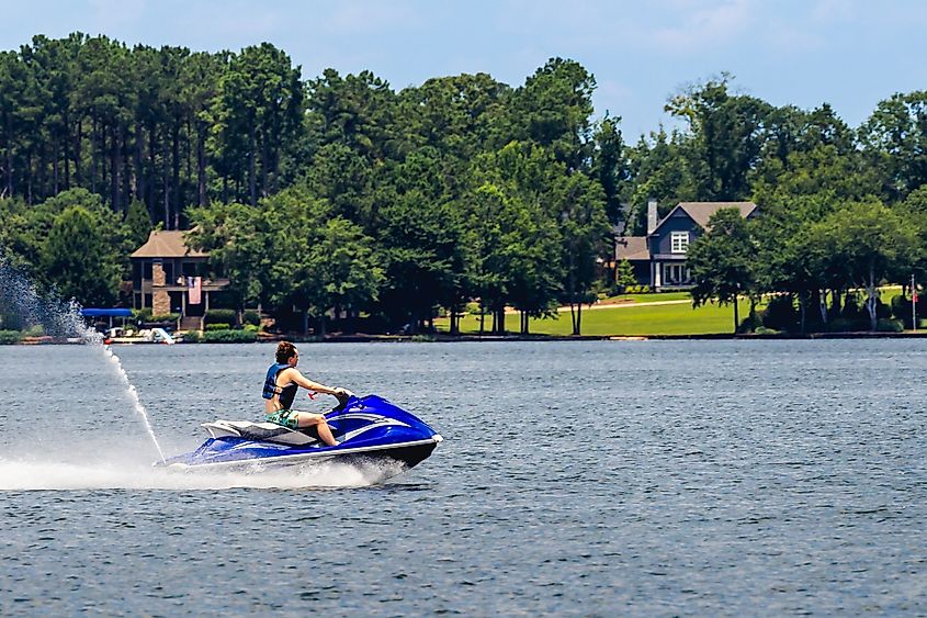 Man riding jet ski and enjoying a summer day on Lake Oconee, Greensboro, Georgia, USA.