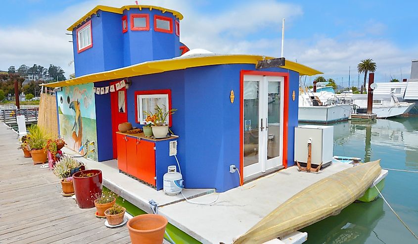 Colorful blue houseboat with red and yellow trim in Sausalito California