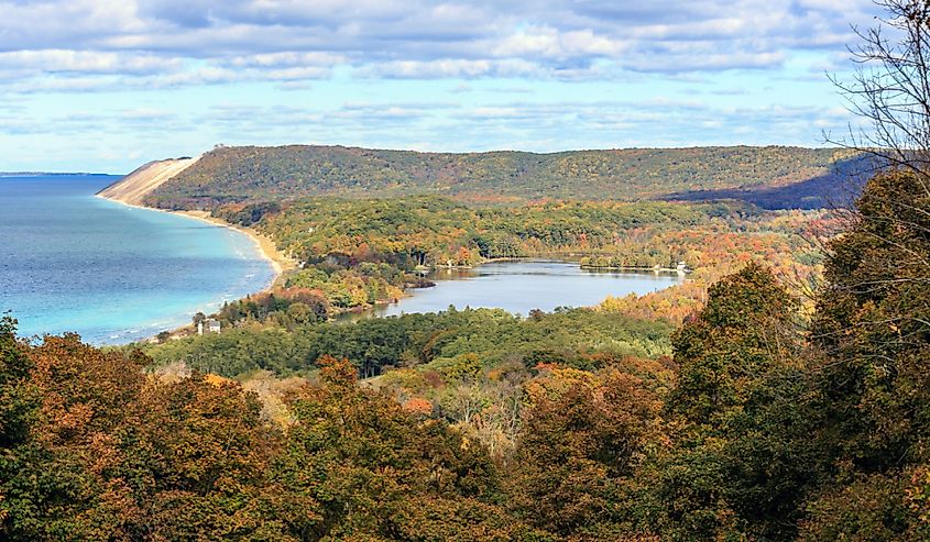 South Bar Lake and Lake Michigan, as seen from Empire Bluff Trail. This plateau, part of Sleeping Bear Dunes is a dominant part of the scene. South Manitou Island can be seen in the distance.