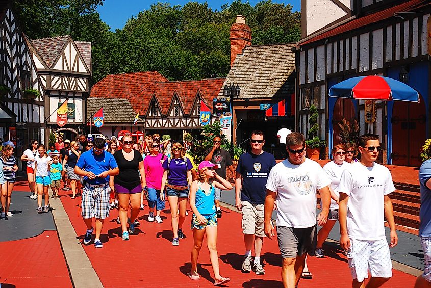 Williamsburg, Virginia: A crowd of people make their way through a recreated Tudor Village in Busch Gardens, in Williamsburg, Virginia.