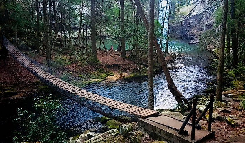 View of the suspension footbridge and the waterfall at Foster Falls along the Fiery Gizzard Trail in South Cumberland State Park in Tennessee.