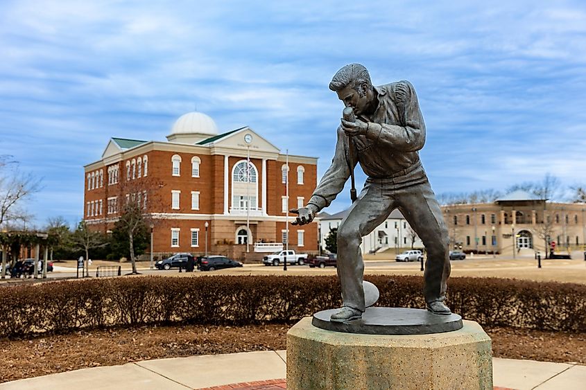 Elvis Presley Statue in Tupelo, Mississippi, with City Hall in the background.
