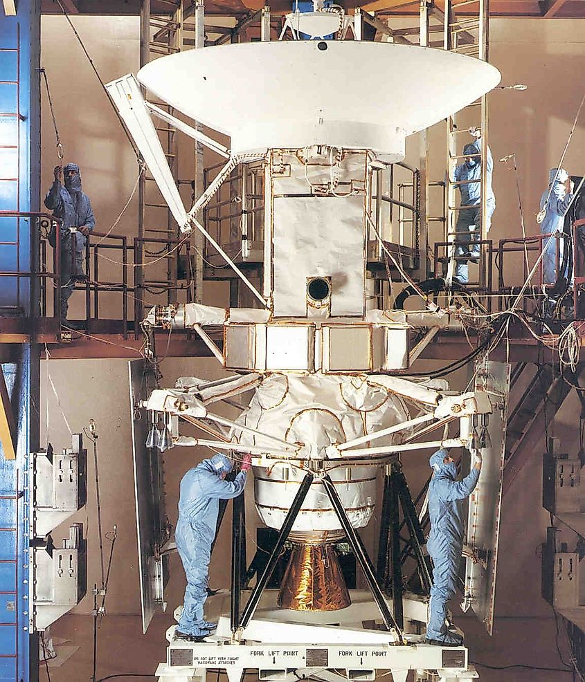 Engineers and technicians at the Martin Marietta plant in Denver, Colorado, prepare the spacecraft for its six-week long trip to the Kennedy Space Center