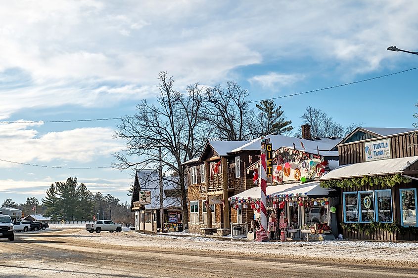 Main street in Nisswa, Minnesota, in winter with stores decorated for Christmas holiday.
