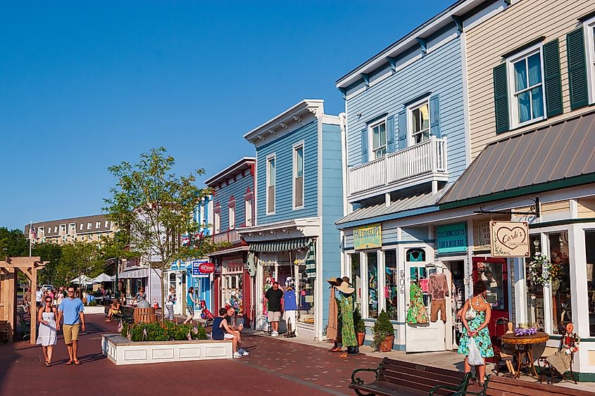 Tourists walk through Washington Street Mall, lined with specialty boutiques, eateries, and shops in Cape May, New Jersey, USA.