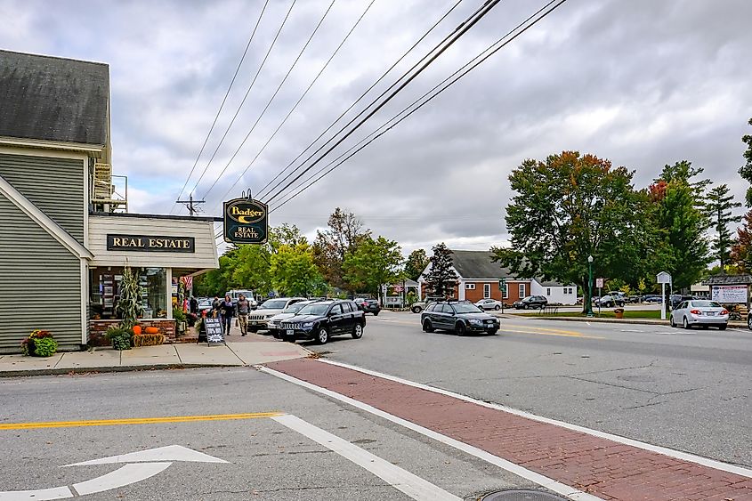 North Conway, Mass, USA - Circa September 2016: Exterior view of an empty side street junction showing a timber-built Real Estate building together with a parking lot at a road junction.