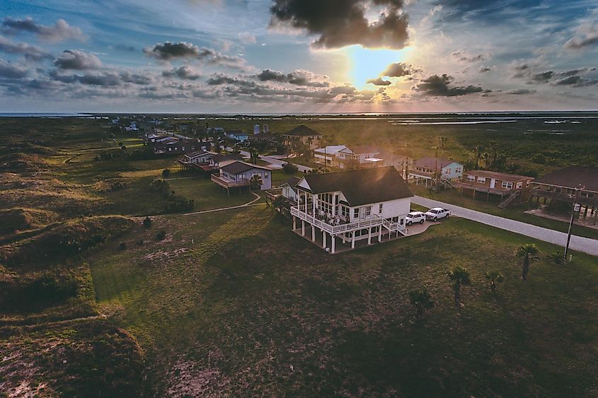 Aerial view of sunset over beach houses on Matagorda Bay, Texas.