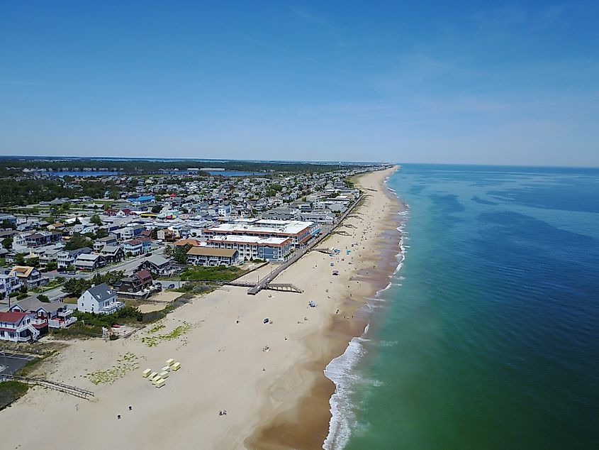 Drone photo of Bethany Beach, Delaware, showing the coastline, beachfront properties, and ocean waves.