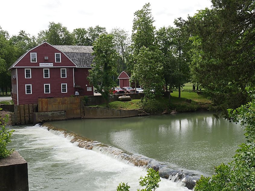 View of the historic War Eagle Mill building across the river in Rogers, Arkansas.