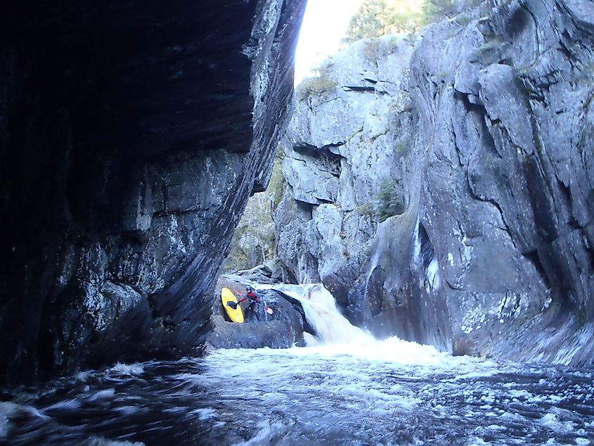 A kayaker portaging the rapid "Wedge" in Gulf Hagas, Maine