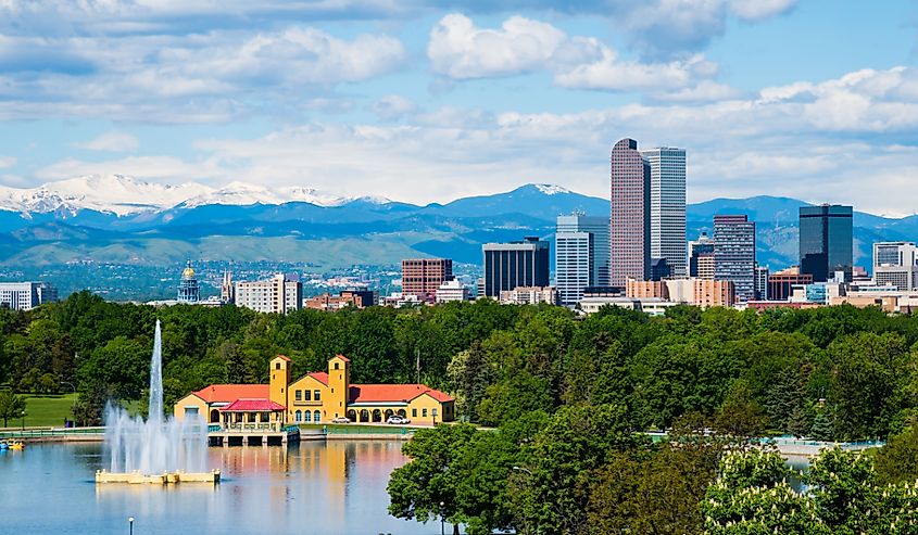 Aerial view of Denver Colorado downtown with City Park with a water feature and the mountains in the background