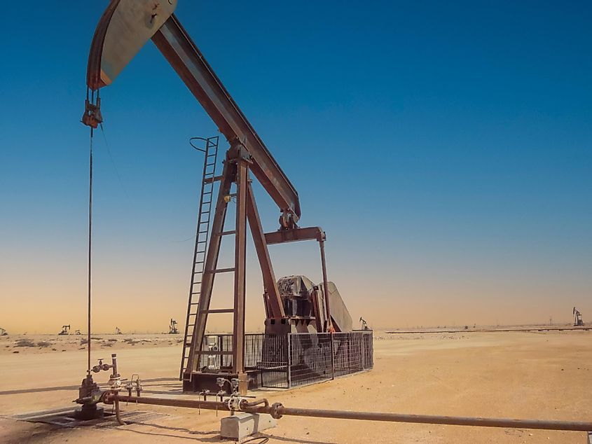 Pump jack in operation in the Arabian desert in the Oman. Image used under license from Shutterstock.com.