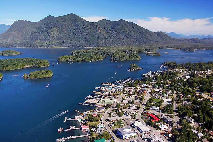A bird's eye view of the town of Tofino, B.C. Mountains and deep blue waters surround the small community. 