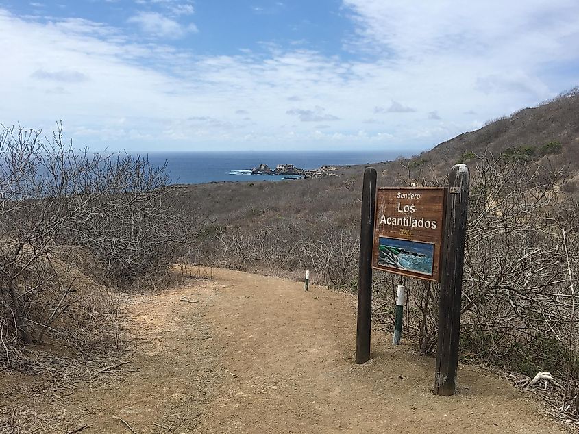 A trail marker from high atop an island hike points the way down to the coast.
