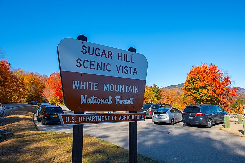 Sugar Hill Scenic Vista sign at Sugar Hill Overlook on Kancamagus Highway in White Mountain National Forest in fall, via Wangkun Jia / Shutterstock.com
