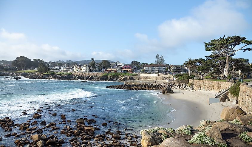 : View of Lovers Point beach and cove, with the Pacific Grove neighborhood in the distance