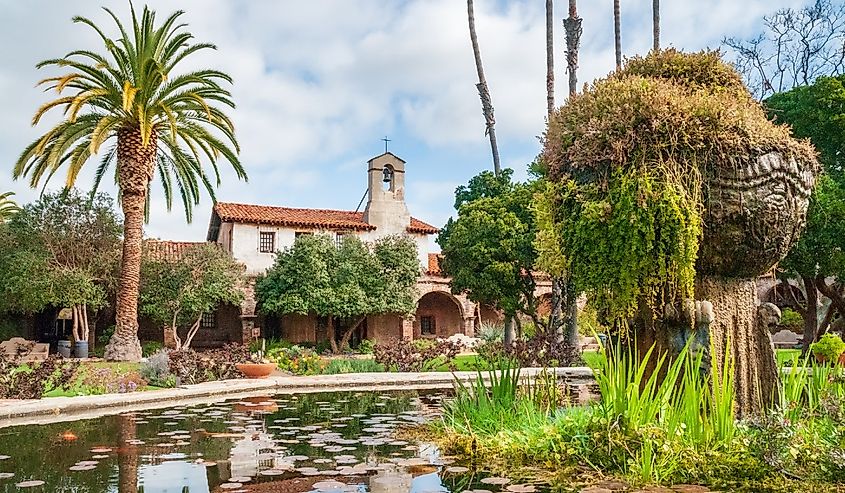 Water features and plants growing outside of Mission San Juan Capistrano.