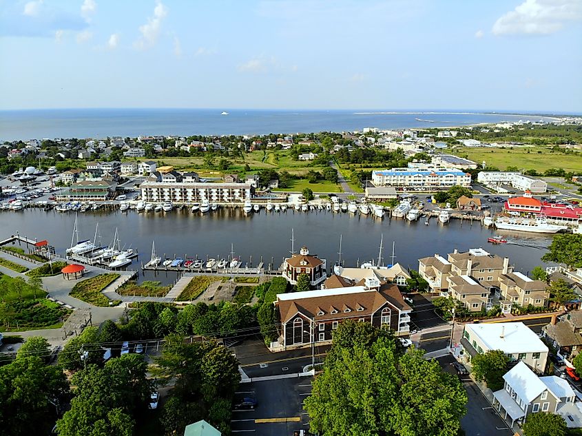 Aerial view of Lewes, Delaware, USA. The beach town, fishing port, and waterfront residential homes along the canal are visible.