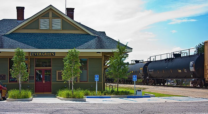 Freight train passing by the L & N depot in Evergreen, Alabama