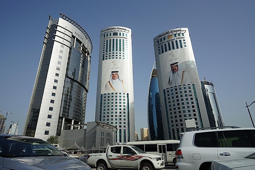View of the Alfardan Towers twin skyscrapers located in the West Bay area of Doha covered with pictures of the ruling Al Thani emir of Qatar and his father. Editorial credit: EQRoy / Shutterstock.com