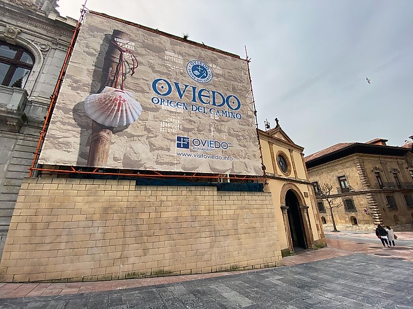 A sign on a stone building in Oviedo, Spain, marking the start of the original Camino de Santiago route.