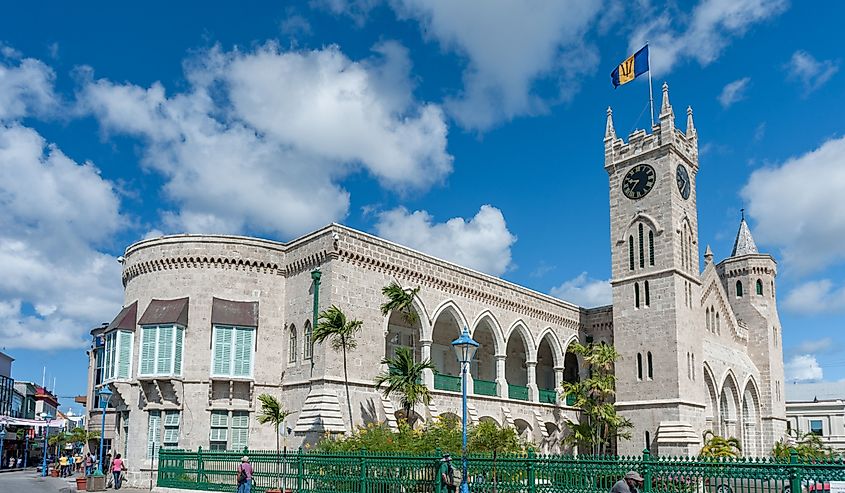 People walking outside of the Barbados Parliament.