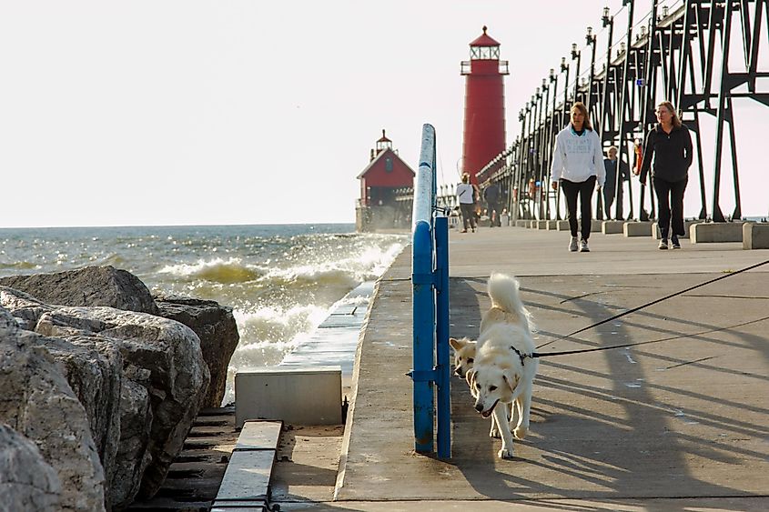Evening walks on Pier leading to the historic lighthouse in Grand Haven, Michigan.