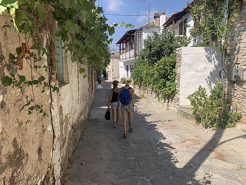 Two women walking the quaint streets of a village in Greece.
